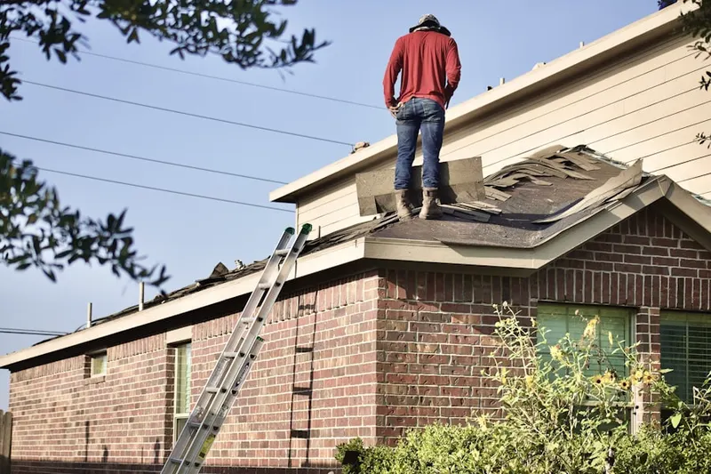 Professional roofer working on a residential roof in Carriage Hill
